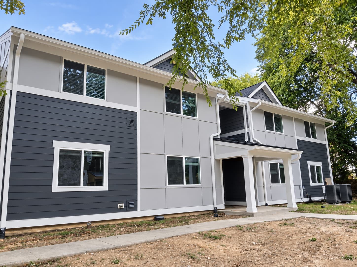Exterior renovation project with gray siding and white trim